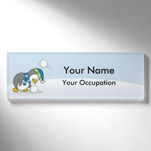 Kleiner Pinguin bekommt eine Schneeball Name Marki Namenschild