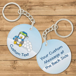 Kleiner Pinguin sitzend mit Snowballs Schlüsselanh Schlüsselanhänger