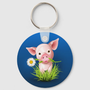 Kleines rosa Schwein in grünem Gras über blau Schlüsselanhänger
