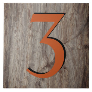 Kupfer Glow House Number Tile 3 auf grauem Stein Fliese