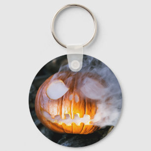 Kürbis mit Jack-o-Lantern-Gesicht brennt Schlüsselanhänger