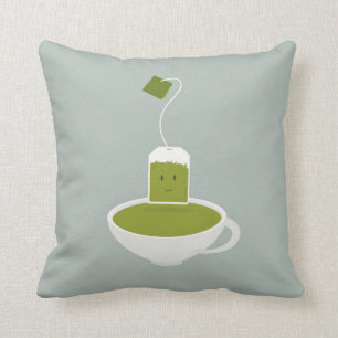 Lächelnde grüne Teetasche mit Teetasse Kissen