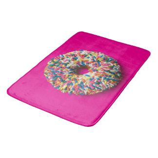 L'arc-en-ciel arrosent le tapis de bain de beignet