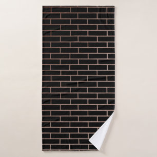 Le mur en brique noire foncée a une surface rugueu
