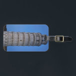 Leaning Tower at Dusk Gepäckanhänger<br><div class="desc">This captivating photograph showcases the iconic Leaning Tower of Pisa standing elegantly against a deep blue twilight sky in Pisa. The historic marble tower, famous for its unmistakable tilt, is beautifully illuminated, highlighting its intricate Romanesque arches and layered columns. The soft evening light creates a striking contrast between the glowing...</div>