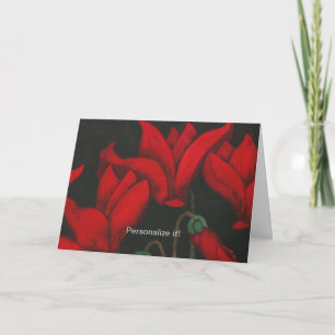 Lebhafte rote Cyclamen blühen auf dunkelschwarzem  Karte