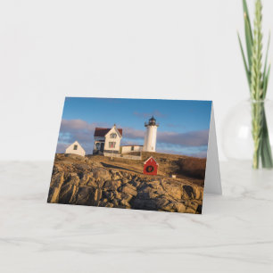 Leuchtturm bei Sonnenuntergang mit Weihnachtsdekor Feiertagskarte