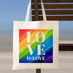Liebe ist Liebe stolz Tragetasche<br><div class="desc">Dieser Pride Tote Beutel ist mit LIEBE IS LIEBE in fett-weißen Buchstaben auf einem Aquarelluntergrund aus Rot, Orange, Gelb, Grün, Blau und lila. Original Wasserfarbe © Michele Davies.</div>