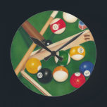 Lifelike Billiards Table with Balls and Chalk Runde Wanduhr<br><div class="desc">Rack 'em up with this spectacular painting of a billiards table by Jennifer Goldberger. The balls look new, the felt looks immaculate, and the chalk has already been applied to the cue sticks. Hang this in your home, or gift it to a friend or loved one who enjoys a game...</div>