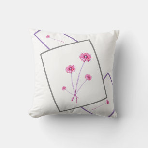 Lila Gerbera-Blume mit hellrosa Kissen