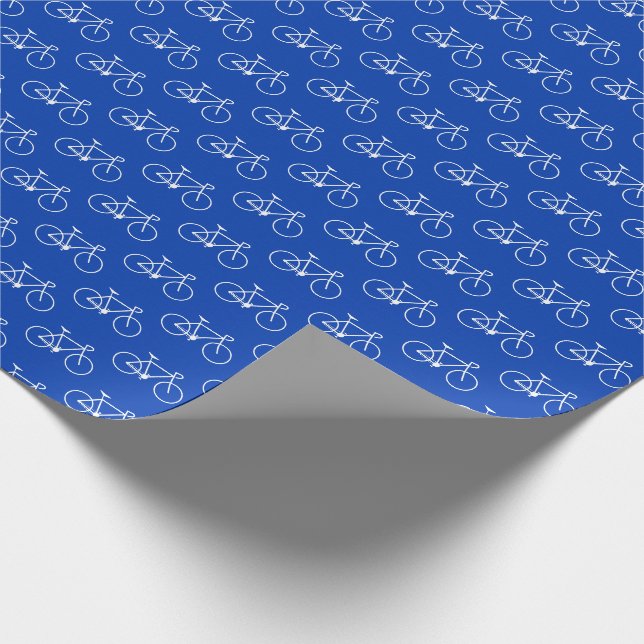 Lose weiße Fahrrad-Formen auf Blau Geschenkpapier (Ecke)