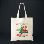 Love Yourself This Christmas Cute Cat Holiday Tragetasche<br><div class="desc">Spread a message of self-love this holiday season with this charming Christmas cat. Featuring a festive kitty in a Santa outfit perched by a decorated tree, this design serves as a gentle reminder to prioritize your own well-being during the holidays. A sweet and meaningful choice for cat lovers and anyone...</div>