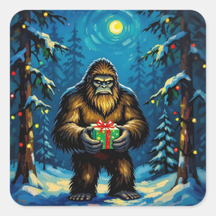 Lustiger Bigfoot hält ein Weihnachtsgeschenk Quadratischer Aufkleber