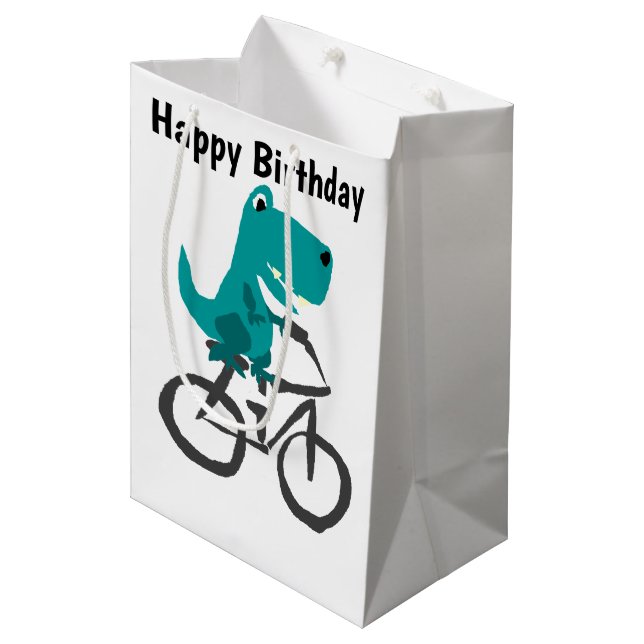 Lustiger T-rex Dinosaurier-Reitfahrrad-Cartoon Mittlere Geschenktüte (Vorderseite Schrägansicht)