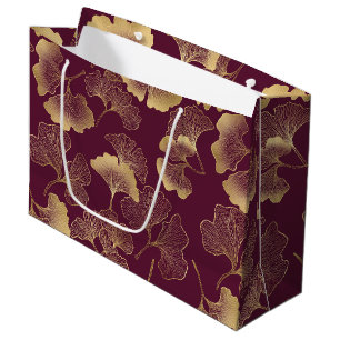 Luxuriöse goldene Ginkgoblätter auf tiefem Burgund Große Geschenktüte