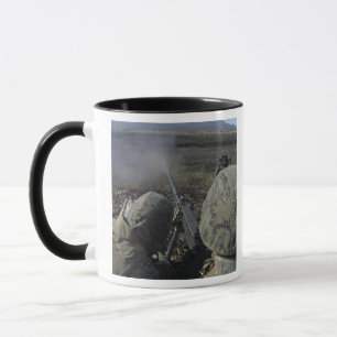 Marinesoldaten feuern ein Kaliber-Maschinengewehr Tasse