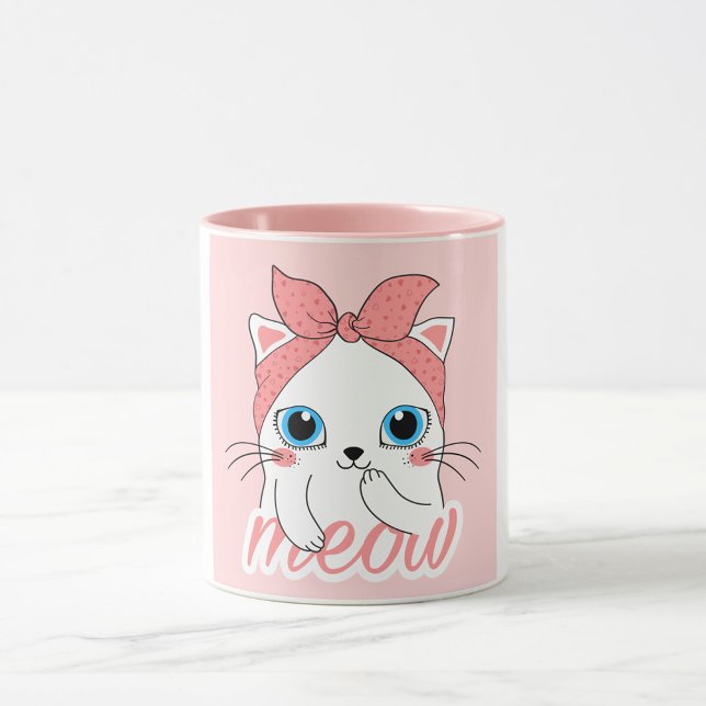 Meow Cat Tasse (A white mug with a pink interior and a pink exterior features a cartoon illustration of a white cat.)