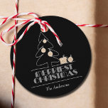 Merriest Christmas Tree Black Holiday Geschenkanhänger<br><div class="desc">Die Wörter Frohe Weihnachten in Retro-Vintage Schrift,  ein weißer Skizzenbaum mit Imitaten goldenen Folienschmuck und Geschenke sind auf diesen schwarzen runden Geschenketiketten oder Gefallen-Tags personalisiert mit Ihrem Familiennamen. Stilvoll für jeden Weihnachtsfeiertag oder als Geschenk der Gastgeberin. PASSENDE Artikel in unserem Geschäft.</div>