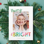 Merry and Bright Tissue Paper Christmas Photo Feiertagskarte<br><div class="desc">This fun, bright Christmas holiday card features colorful text, reading, "Merry & Bright" in green, lime, cherry red, pink, golden yellow, and aqua. The typography for the word "Bright" incorporates an overlapping tissue paper design, which is also included on the back (overlapping Christmas trees). The tissue paper has a crafty,...</div>