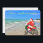 Merry Florida Christmas Sanibel Island Beach Santa Feiertagskarte<br><div class="desc">Frohe Weihnachten in Florida! Diese atemberaubende Ferienwohnung in Sanibel Island verfügt über ein Foto-Image des sensationellen Strandes von Sanibel Island mit dem wunderschönen blau-grünen Wasser des Golfs von Mexiko. Das festliche Design beinhaltet das Fahrrad des Weihnachtsmanns, um Pakete auf dieser Insel Oase zu liefern. Auf der Rückseite der Weihnachtskarte steht:...</div>