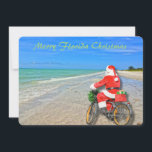 Merry Florida Christmas Sanibel Island Beach Santa Feiertagskarte<br><div class="desc">Frohe Weihnachten in Florida! Diese atemberaubende Ferienwohnung in Sanibel Island verfügt über ein Foto-Image des sensationellen Strandes von Sanibel Island mit dem wunderschönen blau-grünen Wasser des Golfs von Mexiko. Das festliche Design beinhaltet das Fahrrad des Weihnachtsmanns, um Pakete auf dieser Insel Oase zu liefern. Auf der Rückseite der Weihnachtskarte steht:...</div>