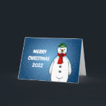Merry und Happy Snowman Feiertagskarte<br><div class="desc">Der frohe Schneemann mit einem grünen Hut und einem roten Schal ist zu Weihnachten bereit.</div>