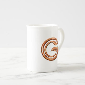 Minimalistischer abstrakter Buchstabe G Prozellantasse