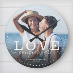 Modern Quote Love Wedding Photo Newlywed Script Runde Wanduhr<br><div class="desc">Custom modern chic photo clock with hand-lettered script and modern typography reading:' Love conquers all ' alongside your custom names and wedding date. Personalize with your favorite photo and information. Great gift for newlyweds,  an anniversary or Valentine's Day!</div>
