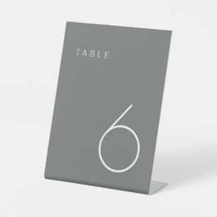 Moderner Minimalistischer Grautisch mit weißer Tis Sockelschild