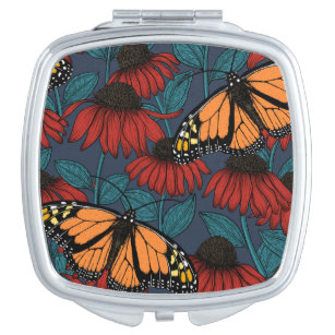 Monarch butterfly on red coneflowers taschenspiegel