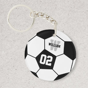 Monogramme sportif de balle de football noir et bl