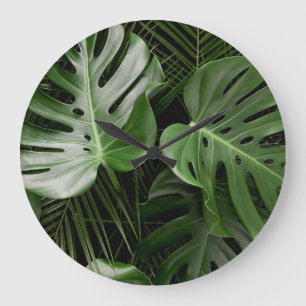 Monstera Blätter, luxuriöse tropische Anordnung. Große Wanduhr