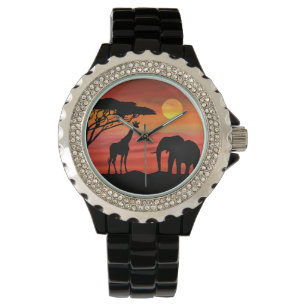 Montre Éléphant et rhinocéros dans le coucher du soleil d