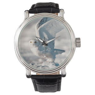 Montre Hibou des neiges décollant de la neige