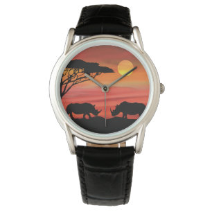 Montre Les beaux rhinocéros dans le coucher du soleil du