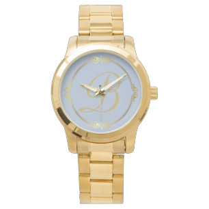 Montre Monogramme en or avec cercle infini sur bleu  