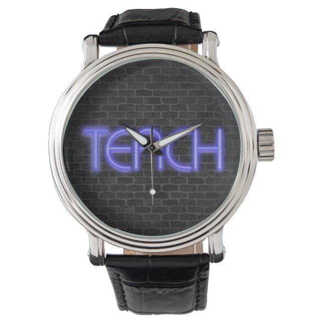Montre néon brillant TEACH texte sur brique (devant)