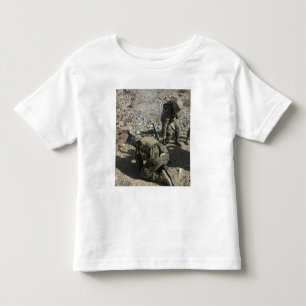 Mortarmen Abdeckung ihre Ohren und wenden ihre Kleinkind T-shirt
