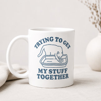 Mug Chat qui essaie de rassembler mes affaires