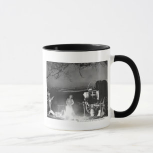 Mug Cowboys jouant et chantant autour d'un feu de camp