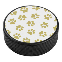 Muster von Pfoten, Hundeschäften, goldenen Pfoten Eishockey Puck