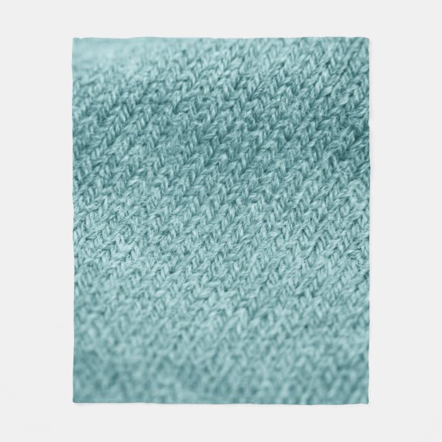 Nah aus grün gestricktem Hintergrund.  Fleecedecke (Vorderseite)