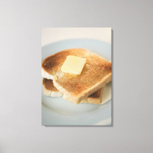 Nah oben von den Toast mit Butter auf Platte Leinwanddruck