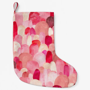 Nahtloses Muster aus rosa, roten und beigen Flecke Kleiner Weihnachtsstrumpf