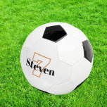 Name der schwarzen Monogramm-Initialnummer Fußball<br><div class="desc">Stilweißer Hintergrund und schwarzer,  weißer,  goldfarbener Text. Personalisieren Sie Ihren Namen und Ihre Spielernummer und fügen Sie diese hinzu.</div>