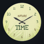 Nature Time Botanical Soft Green Große Wanduhr<br><div class="desc">This beautiful Nature Time wall clock features a soft light green background inspired by fresh spring grass and natural textures. Gentle shadows of tropical leaves create a calming botanical effect that brings a sense of nature and freshness into your space. The dark green and brown typography complements the light green...</div>