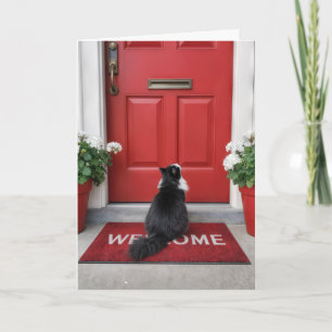 Neues Haus mit Katze auf einer roten Willkommen-Ma Karte