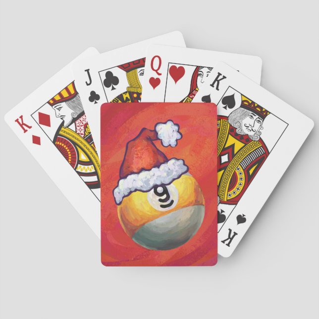Neun Ball in Weihnachtsmannmütze über Rot Spielkarten (Rückseite)