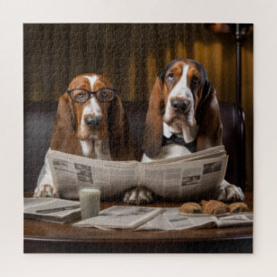 Niedliche Basset-Hunde beim Lesen einer Zeitung