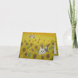 Niedliche Katzen in Sonnenblumen verstecken sich u Karte